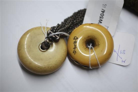 A Japanese Meiji leather tabako-ire or purse with ivory manju netsuke and another ivory manju netsuke